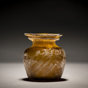 A Roman Amber Glass Jar with Diagonal Ribbing